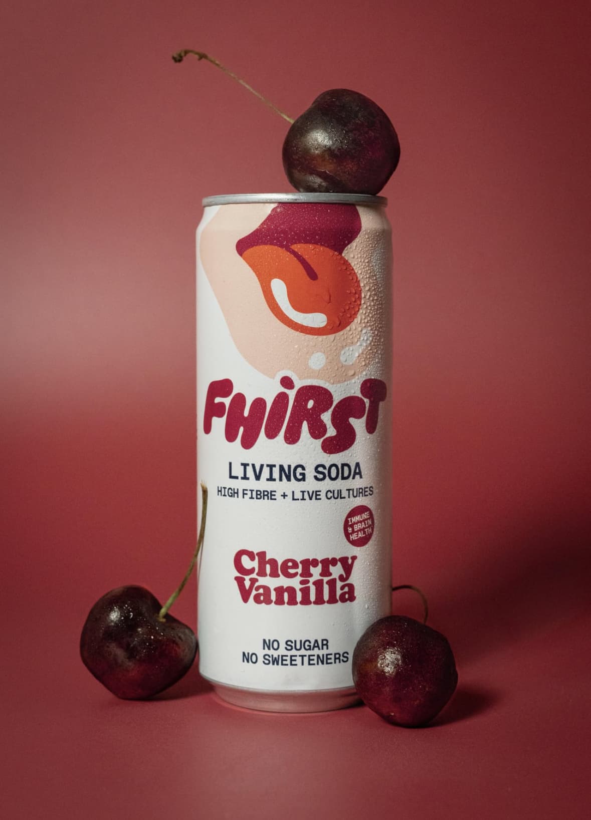 The product photo: a can of cherry soda with cherries on a red backdrop